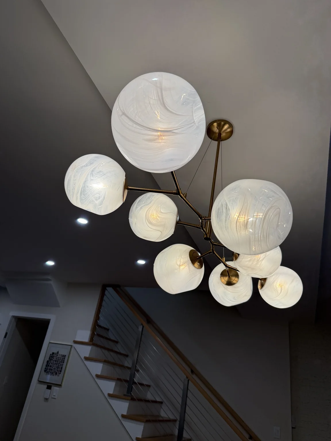 Large statement chandelier and recessed lighting installation
