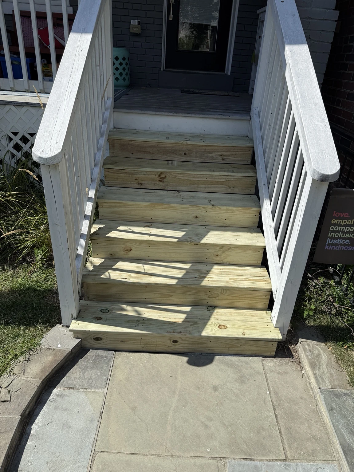 Finished exterior staircase rebuilt with pressure-treated treads and risers